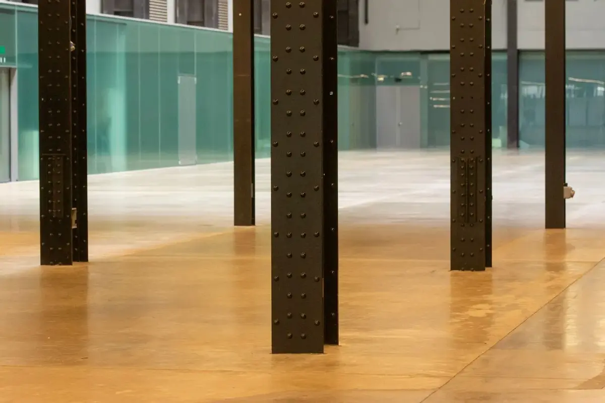an amber-toned coated floor in a commercial space with columns